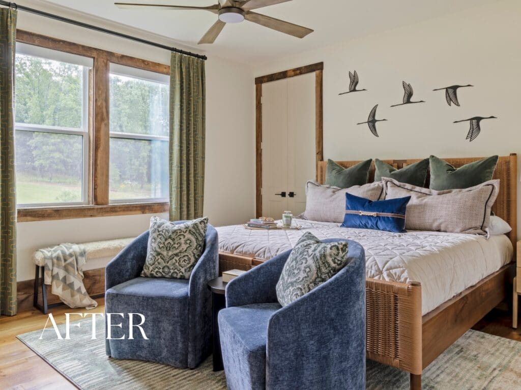 Luxury Ozark mountain retreat guest suite designed by Baker Design Group, featuring two beds with custom green upholstered headboards, natural woven window shades, and a cozy blue armchair.